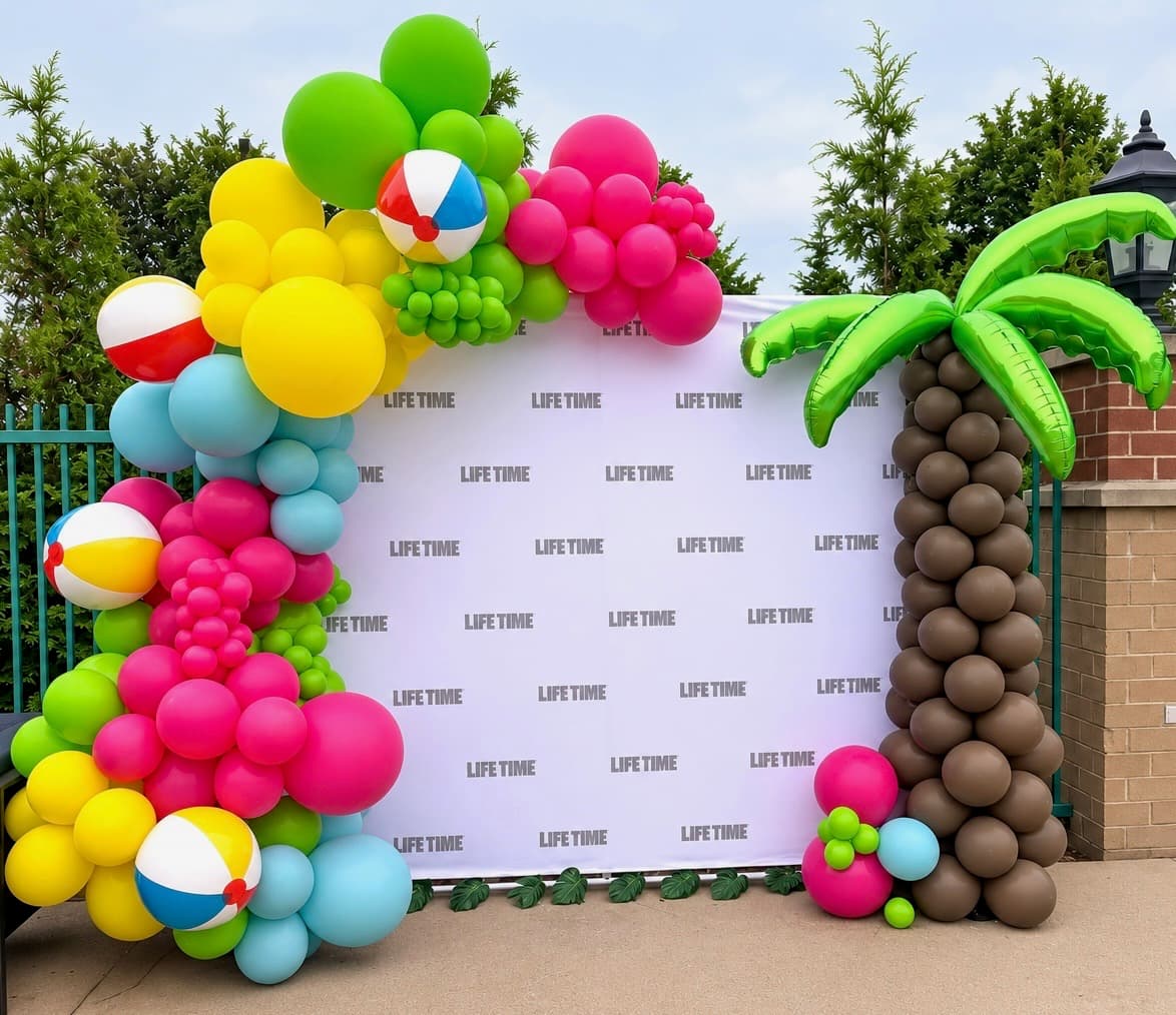 Colorful balloon installation framing a branded backdrop for a business event