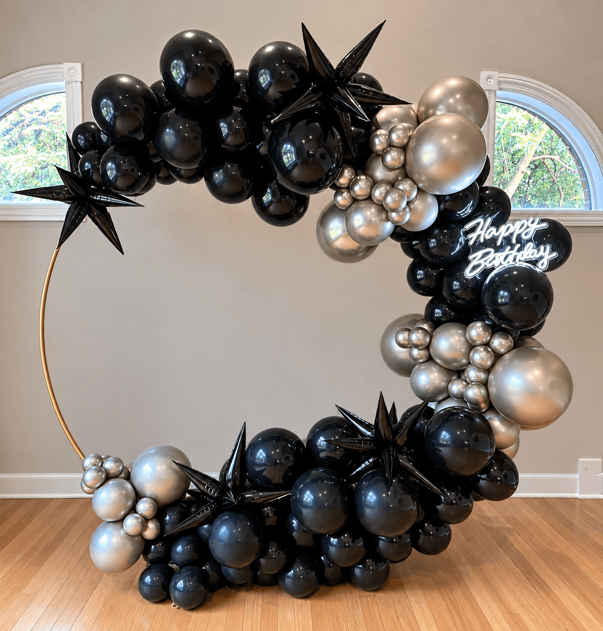 Black and silver balloon ring with metallic starbursts