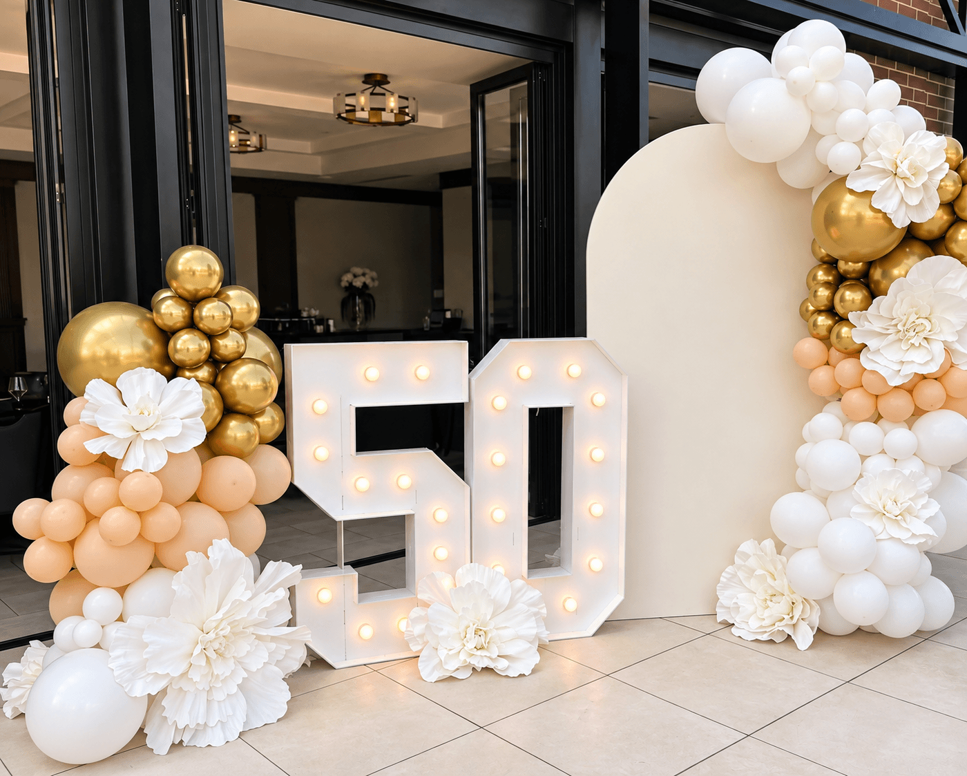 Gold, peach, and white 50th birthday backdrop